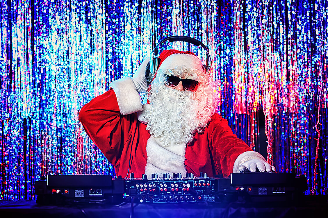 DJ Santa Claus mixing up some Christmas cheer. Disco lights in the background.