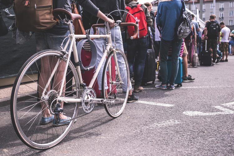 People waiting in line, bike.